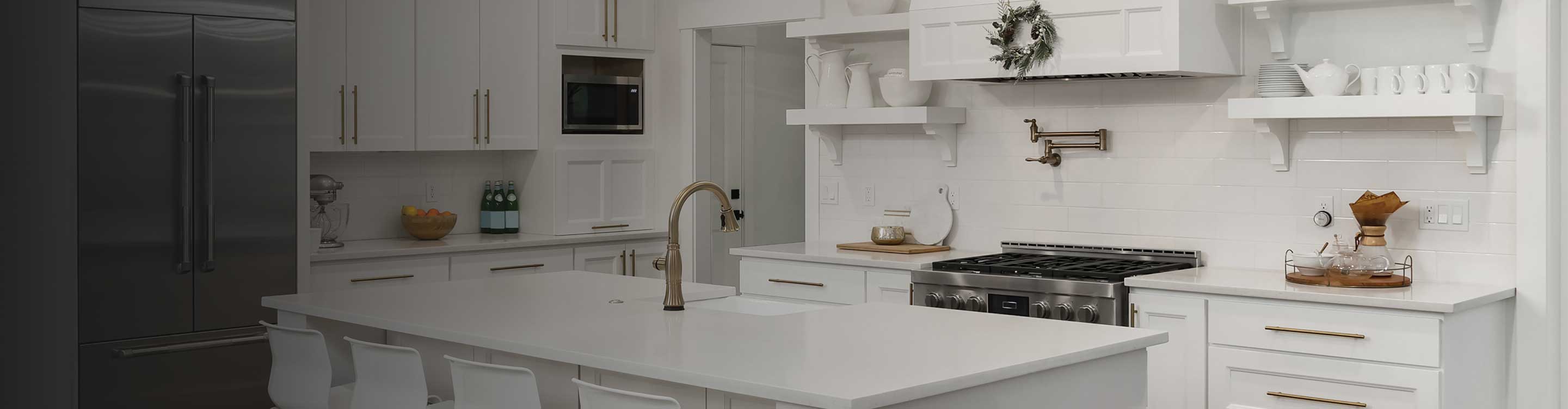 Kitchen with marble floors and white cabinetry
